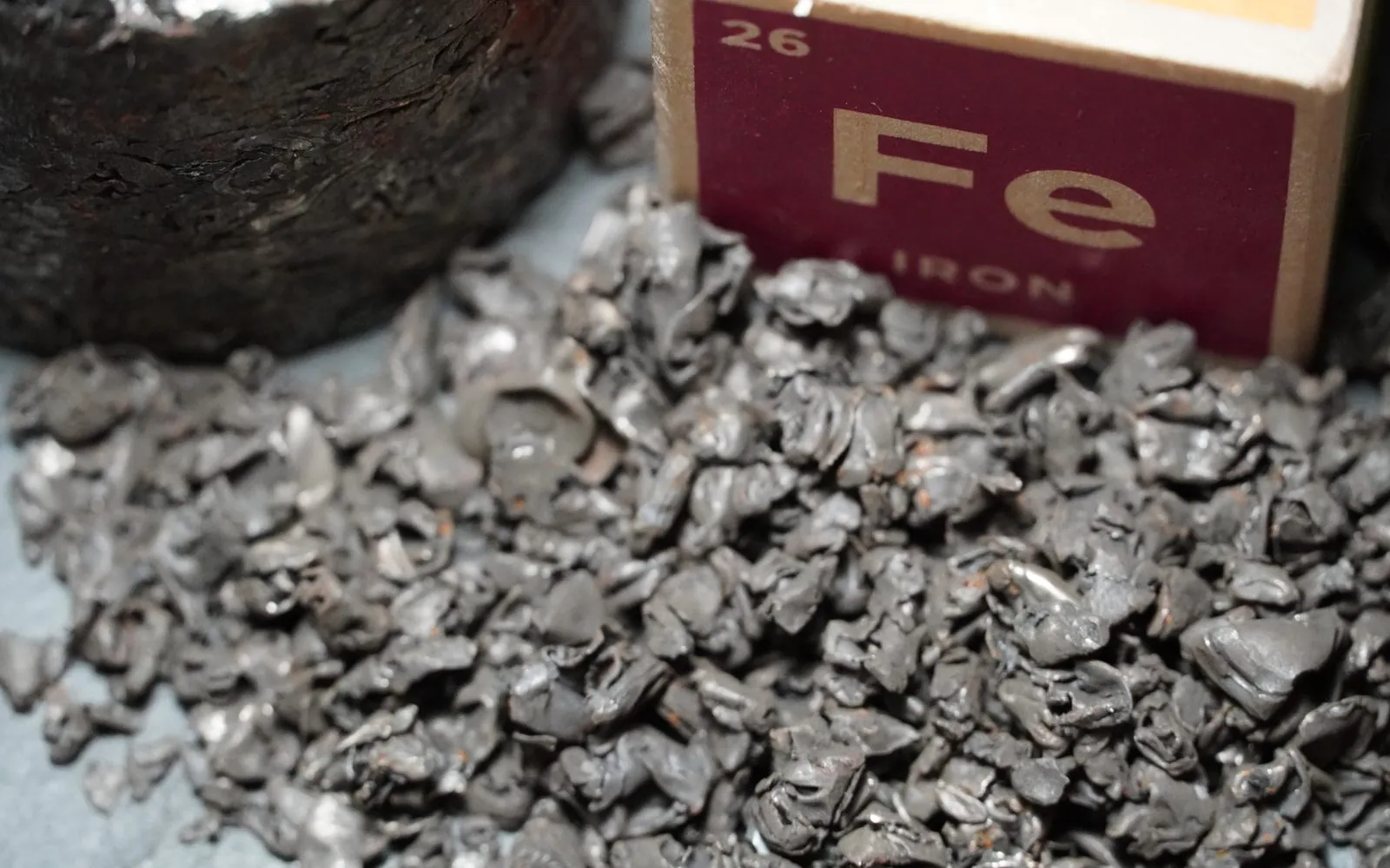 Recovered shredded steel beside a labelled iron sample box
