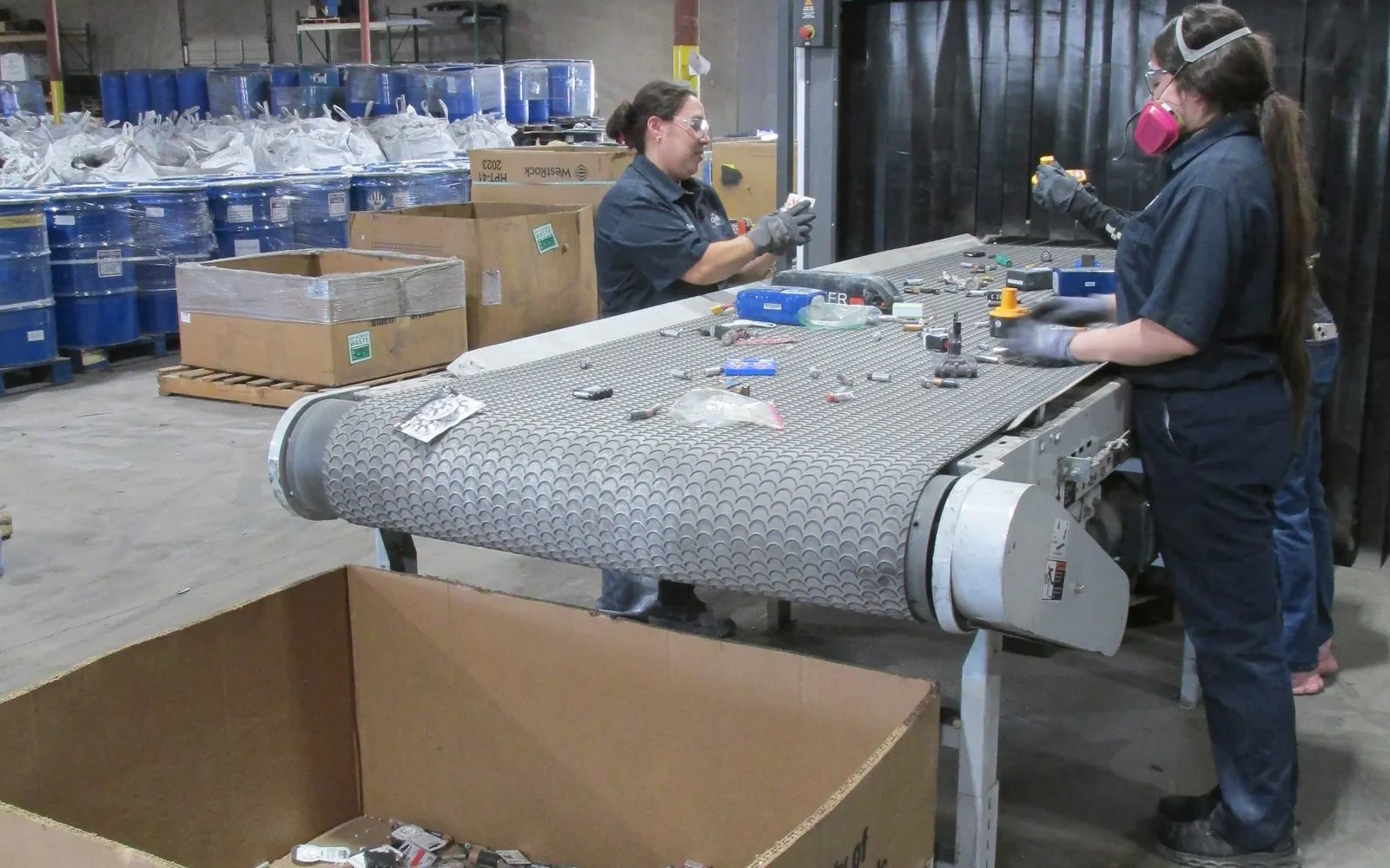 Operators checking cells on the sorting belt before size reduction