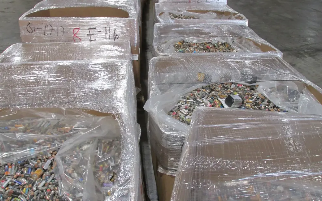 Shrink wrapped pallets of spent alkaline batteries staged for collection