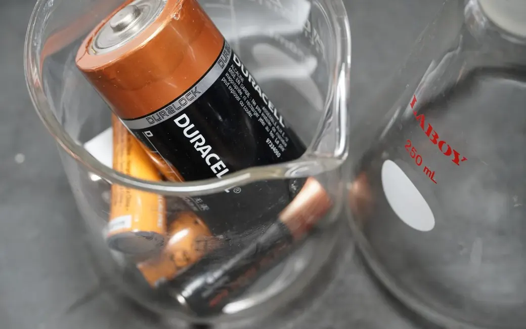 Alkaline cells in a laboratory beaker during sample testing