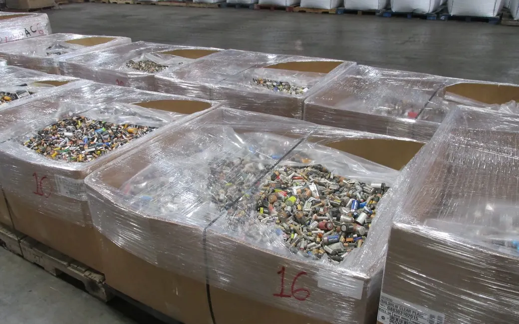 Pallets of sorted spent batteries wrapped and staged on the plant floor